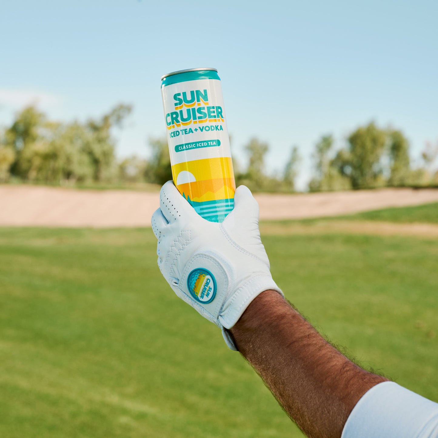 Golfer wearing a white Sun Cruiser X GFore golf glove, holding a Sun Cruiser Classic Iced Tea