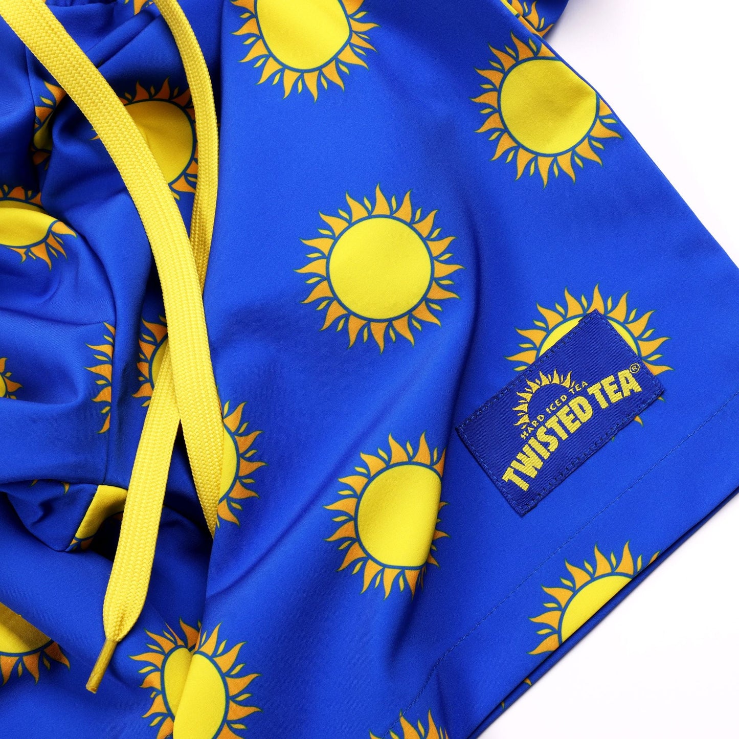 Blue jacket with yellow sun patterns and Twisted Tea logo on a white background