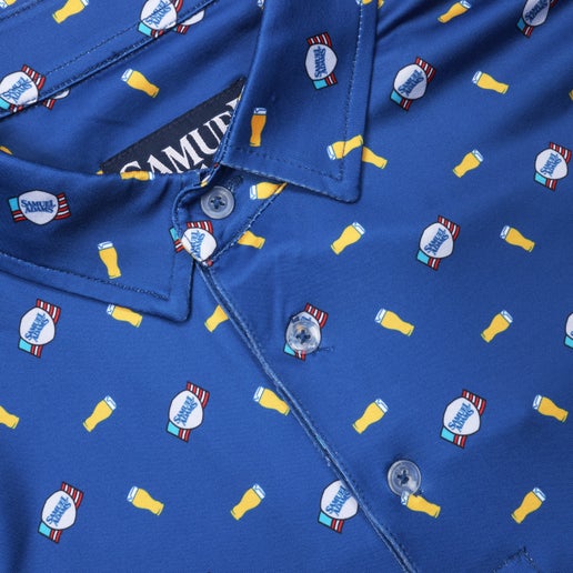 Close-up view of the navy polo shirt’s collar and button placket, highlighting the small repeating print of beer pints.