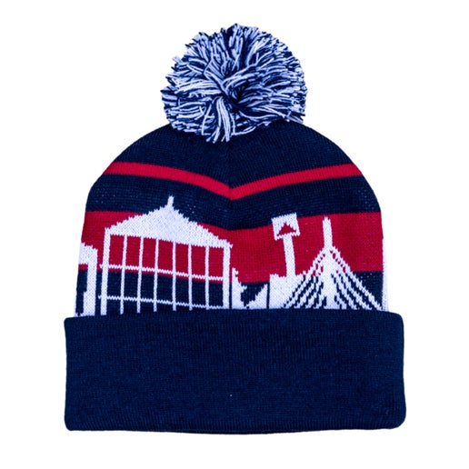 Beanie with a blue base and red stripes, pom on top is blue and white. A white Boston skyline is wrapped around the beanie.