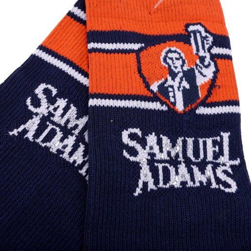 Close-up of calf area which features classic Sam Adams beer hoisting logo and "Samuel Adams" written underneath.