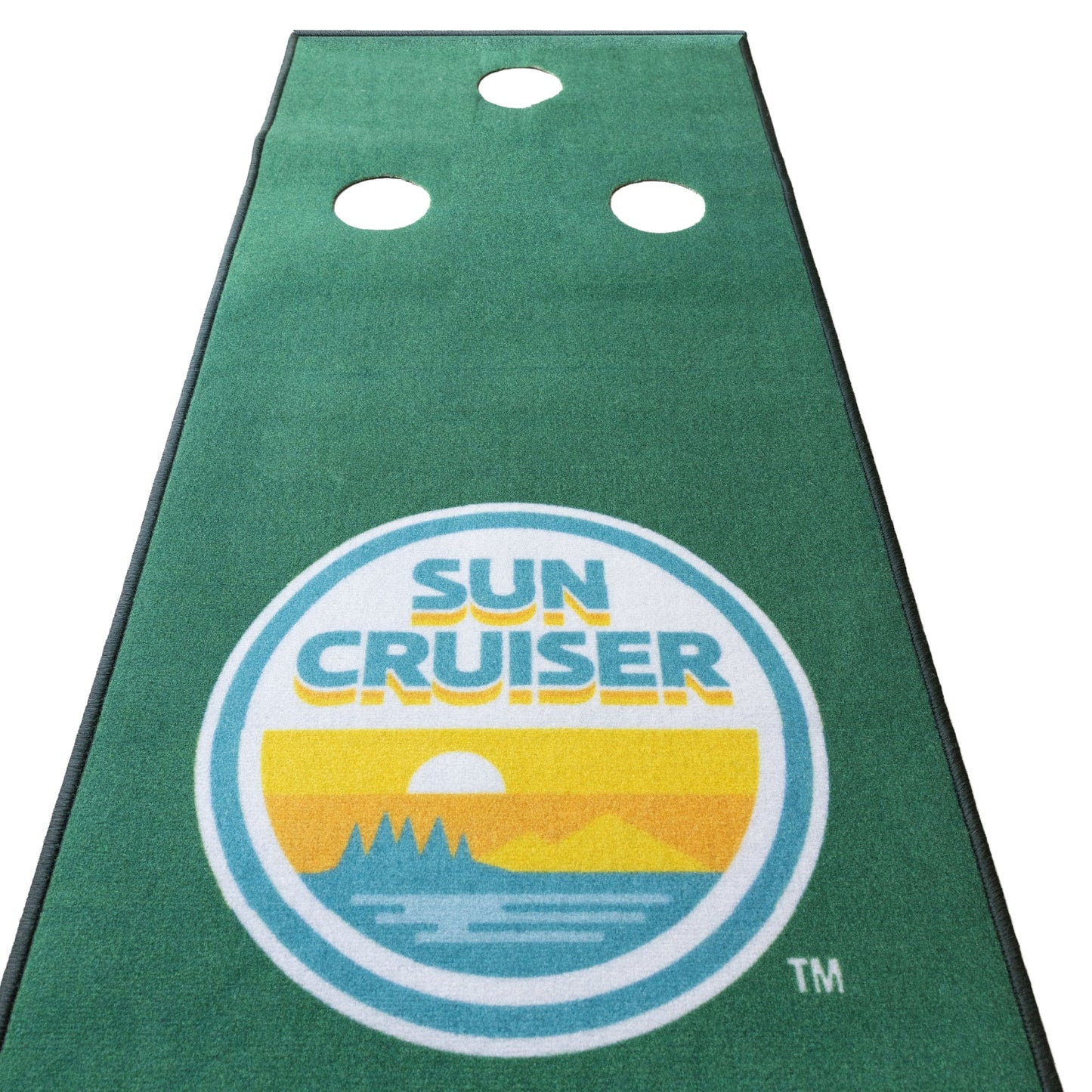 Sun Cruiser putting green practice mat with a long rectangular shape, green turf surface, three white putting holes, and a centered retro Sun Cruiser logo in teal, yellow, and orange.