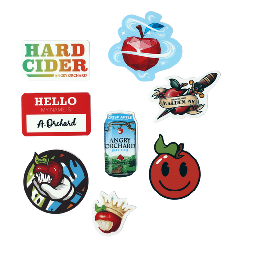 Image of eight assorted stickers. Stickers include: one bitten red apple wearing a crown, one red apple with a smiley face, one Angry Orchard can, one bitten red apple being held by a hand, one apple with writing "Walden, NY" on it, one red name tag with name "A. Orchard", one with writing "Hard Cider" and "Angry Orchard" in a green/yellow/orange/red ombre, and one red apple made to look like a diamond.
