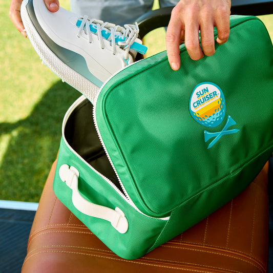 Player putting shoes into Sun cruiser x Gfore golf shoe bag