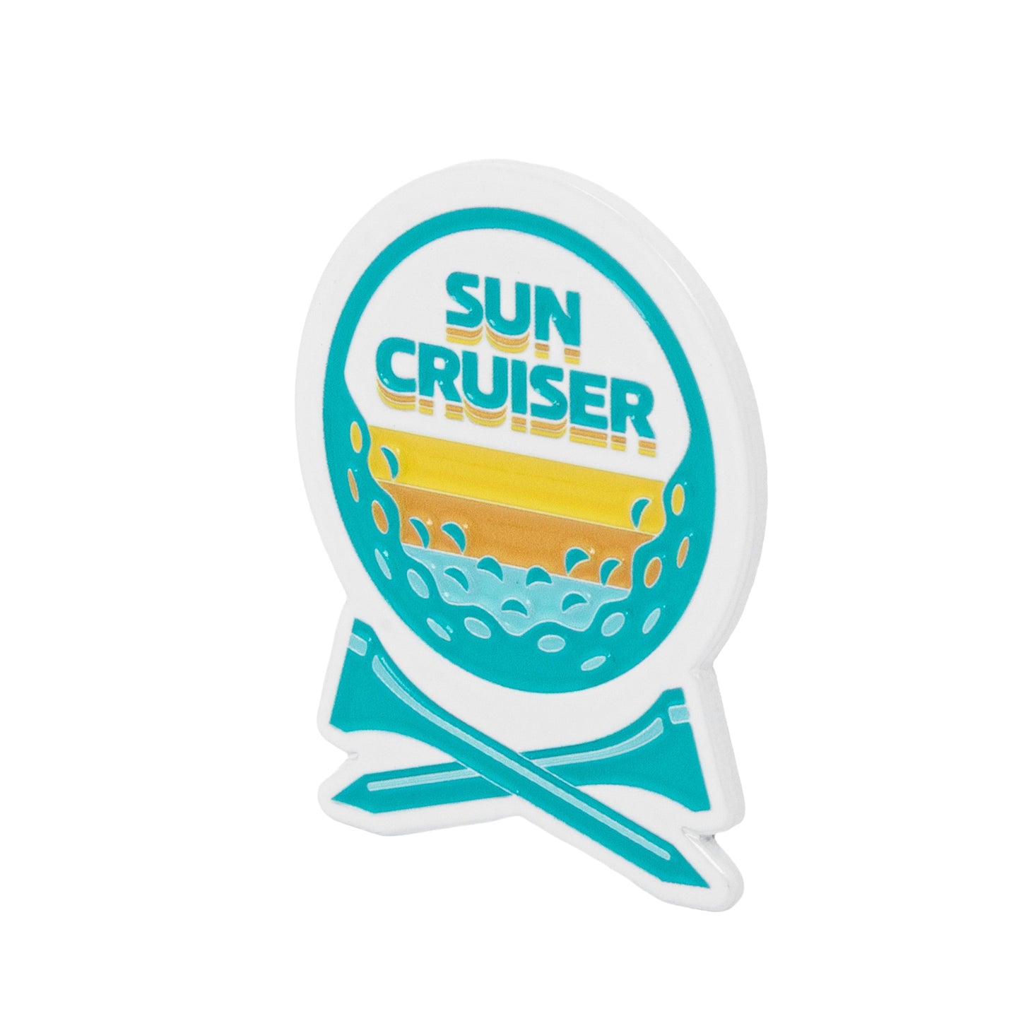 Close-up angled view of Sun Cruiser golf ball marker featuring teal logo, sunset gradient, and beach-inspired golf design