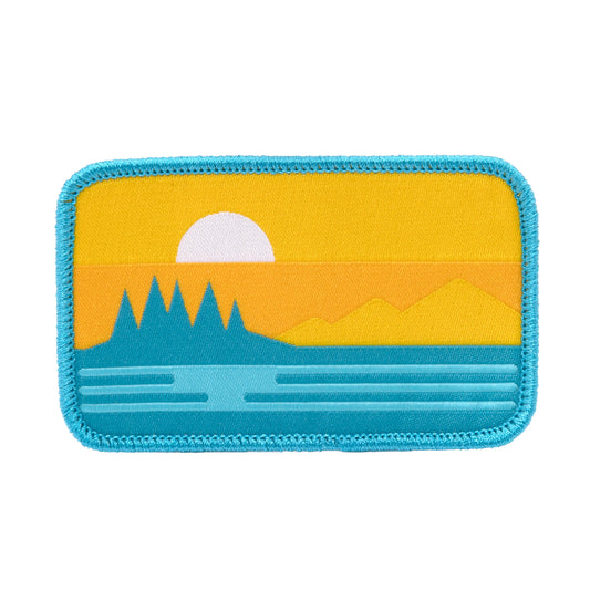 Sun Cruise patch with bright sunset over ocean and mountains, turquoise border embroidered patch 