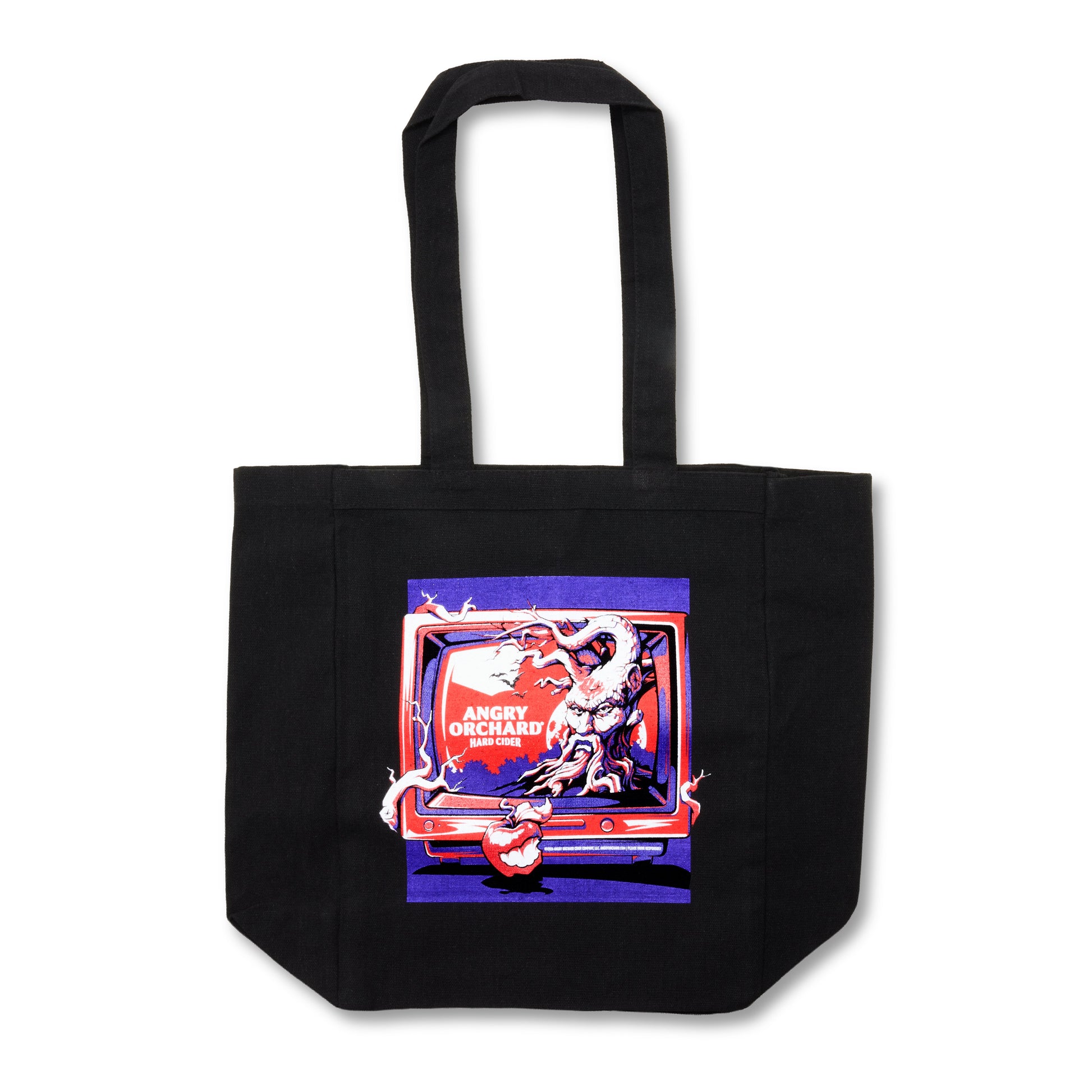 A black canvas tote bag with a colorful graphic print on the front depicting a character in a red and white outfit inside a retro television screen, with the text 'ANGRY ORCHARD HARD CIDER' visible.
