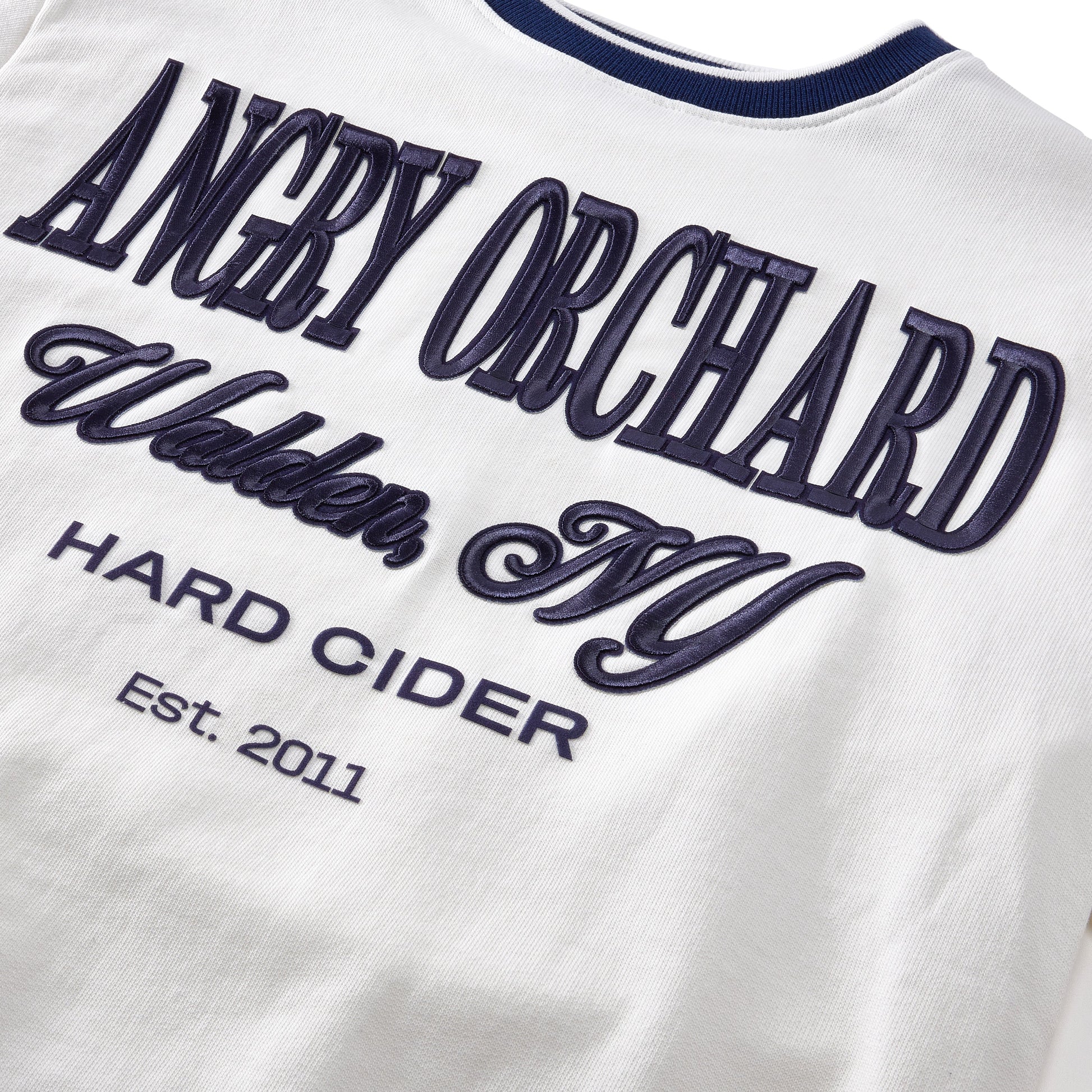 Close‑up of the Angry Orchard White Walden Crew Sweatshirt fabric—soft white knit texture highlighting quality material and craftsmanship of the crewneck sweatshirt