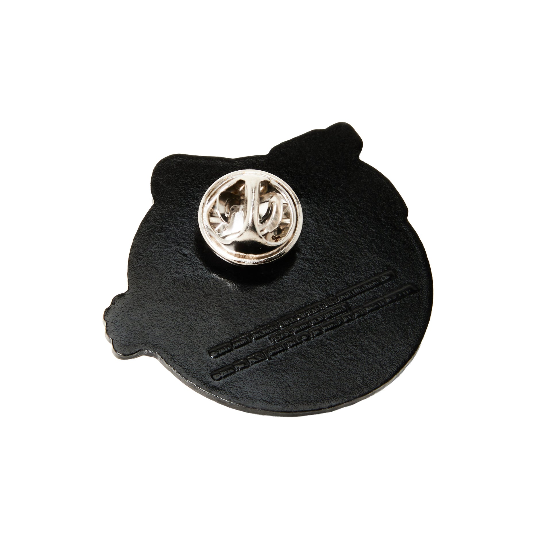 A black  pinback featuring a silver metal pin clasp on top and embossed line details, shown against a plain white background.
