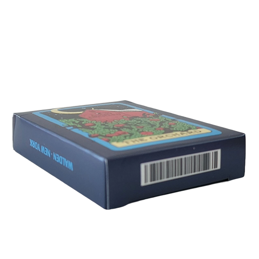 The box and outside of these playing cards display a design of a moonlit orchard on a tarot card. The "name" on the tarot card is "The Orchard".