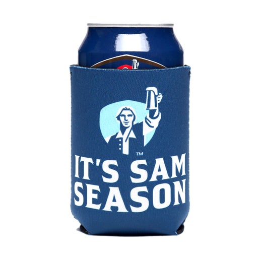A blue 12-ounce can cooler with the Samuel Adams Hoist logo in white, navy, and light blue over text that reads "It's Sam Season".