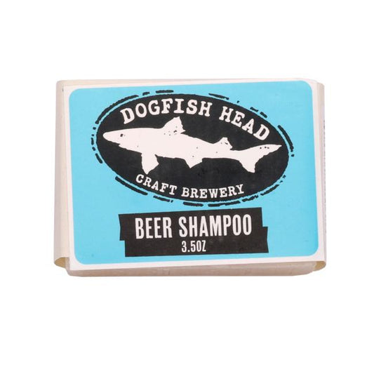 A rectangular bar of Parsonage Handmade Soaps Beer Shampoo wrapped in paper with a blue label reading Beer Shampoo and featuring the brand name at the center.