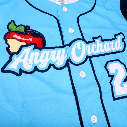 Close-up of front of jersey features writing "Angry Orchard" with bitten red apple, and number two.