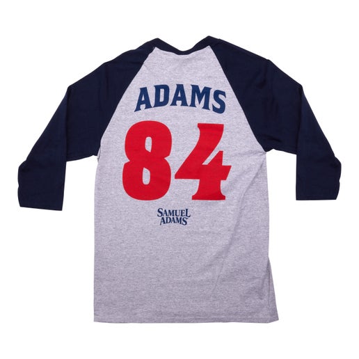 Back of tee features writing "Adams" as the name and large number "84" in red with a small written Samuel Adams logo underneath in blue.