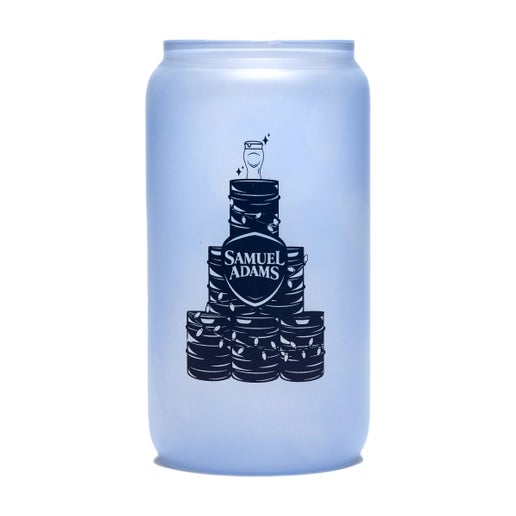 A frosted glass with a pyramid of kegs wrapped in christmas lights with a perfect pint glass sitting on top and the Samuel Adams classic shield logo in the middle in navy printed on the other side of it that changes color to a blue when it comes into contact with cold.