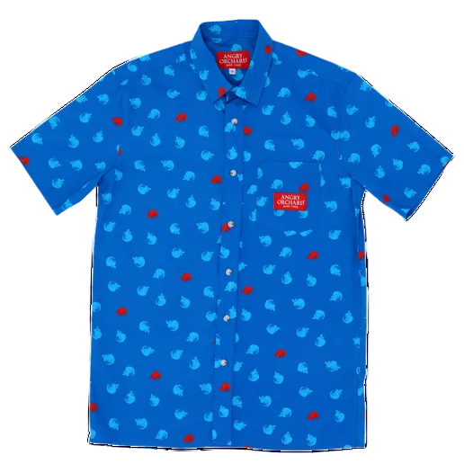 This blue button up is covered in small red and light blue apples. It has a pocket on the left side of the chest and on the pocket is a red patch that says "Angry Orchard Hard Cider".