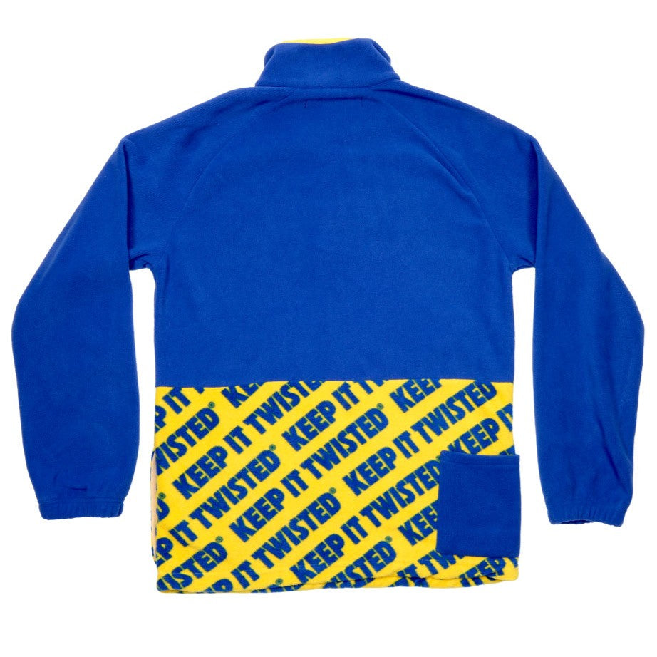 The top half of the fleece is solid blue with a yellow panel for the buttons. The bottom half is yellow with repeating blue writing "Keep it Twisted".