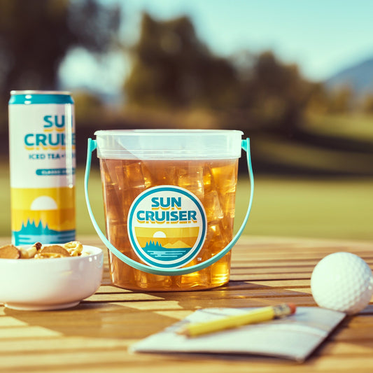 Sun Cruiser iced tea bucket and can on a table with outdoor background