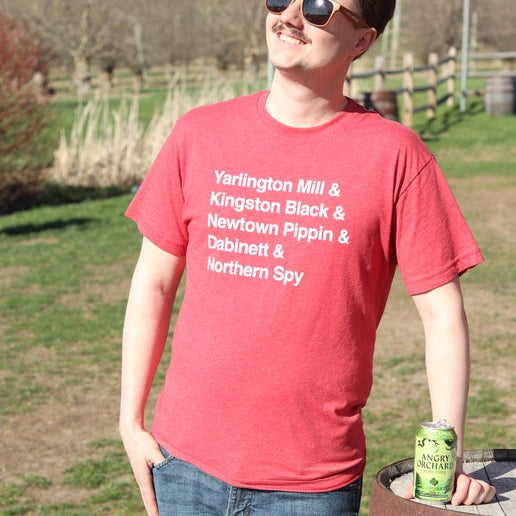 Front of tee is red with writing "Yarlington Mill & Kingston Black & Newtown Pippin & Dabinett & Northern Spy".