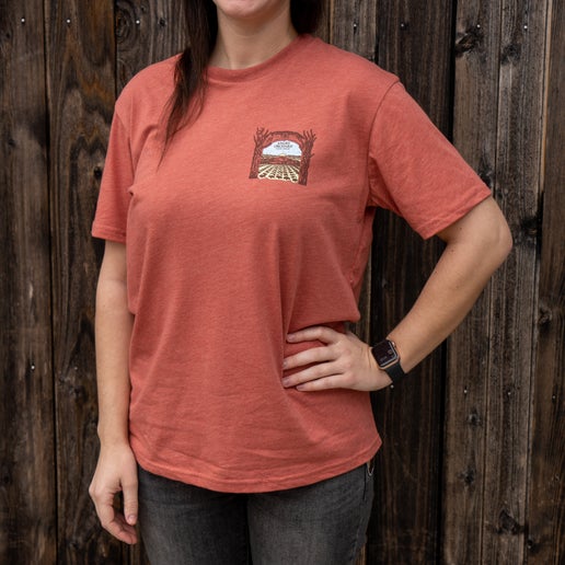 Front of tee displays a small artistic rendition of our Angry Orchard location on the left of chest.