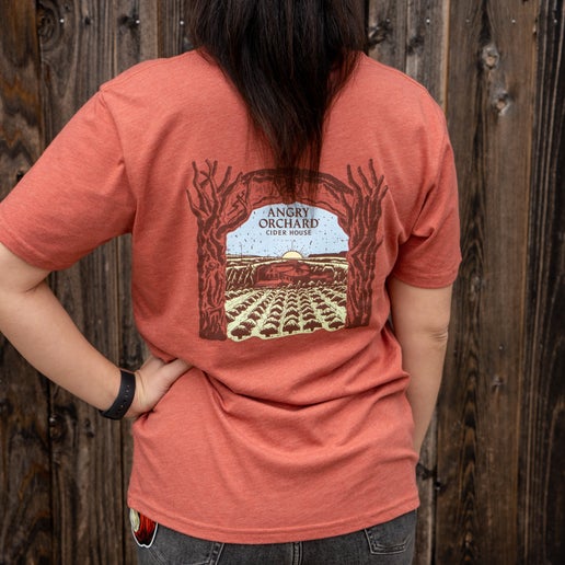 Back of tee displays a larger artistic rendition of our Angry Orchard location.