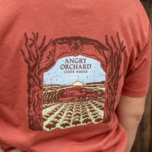 Back of tee displays a larger artistic rendition of our Angry Orchard location.
