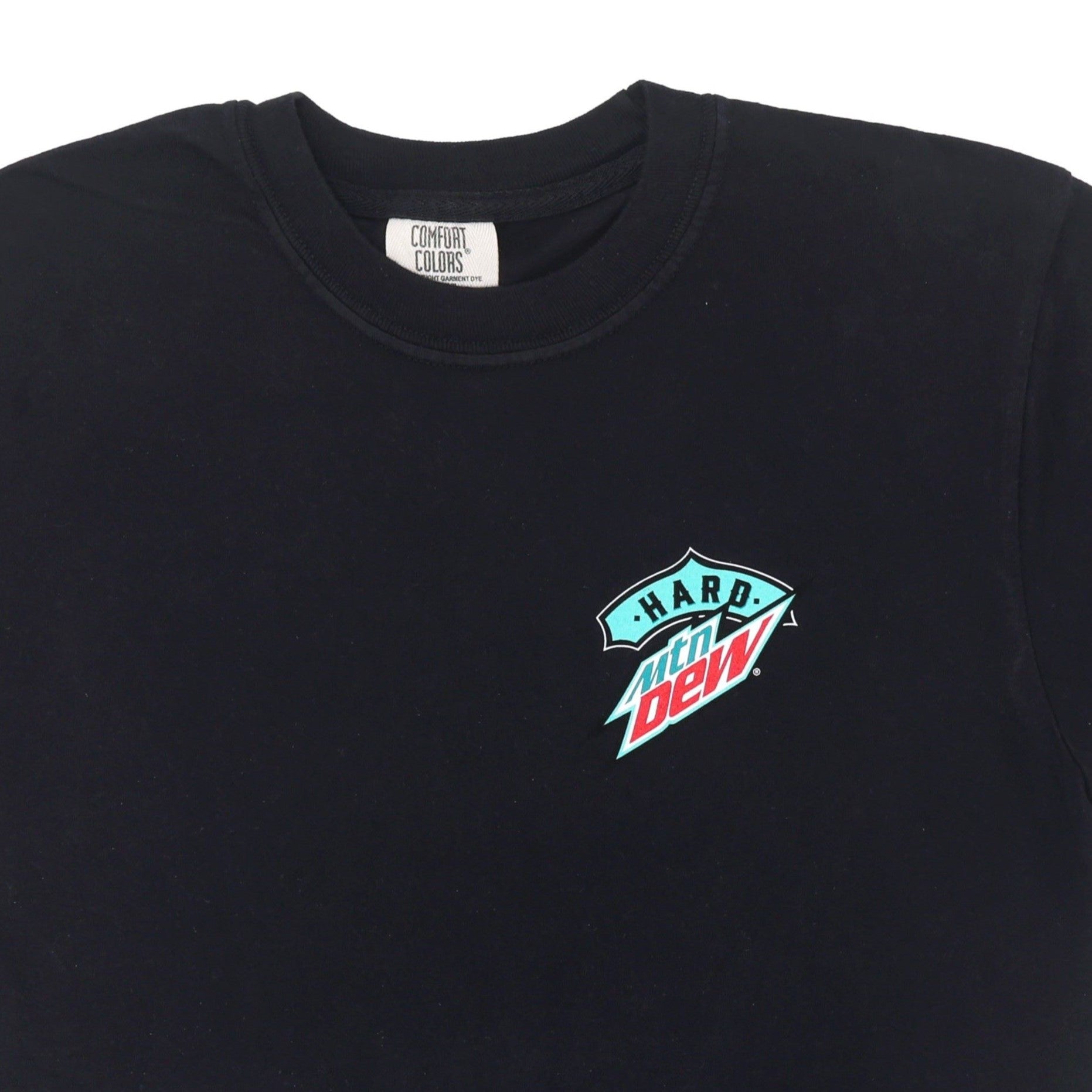 Close-up of the front logo on the black Hard Mountain Dew tee shirt, showing the small teal, white, and red logo on the left chest pocket area.