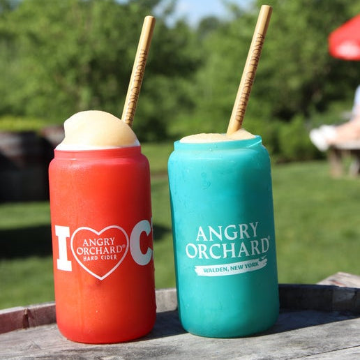 This image shows two different color changing glass. One glass changes to red when cold, and has writing "I heart cider" on it. The heart is an actual heart with writing "Angry Orchard Heart Cider" on it. The second glass turns blue when cold and has writing "Angry Orchard", "Walden, New York" on it.