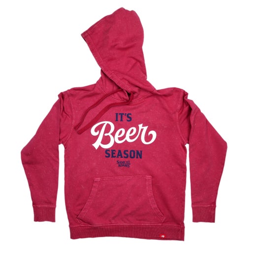 Front and back views of a crimson red hoodie with “It’s Beer Season” and the Samuel Adams logo printed on the chest, featuring a front pocket and drawstring hood.