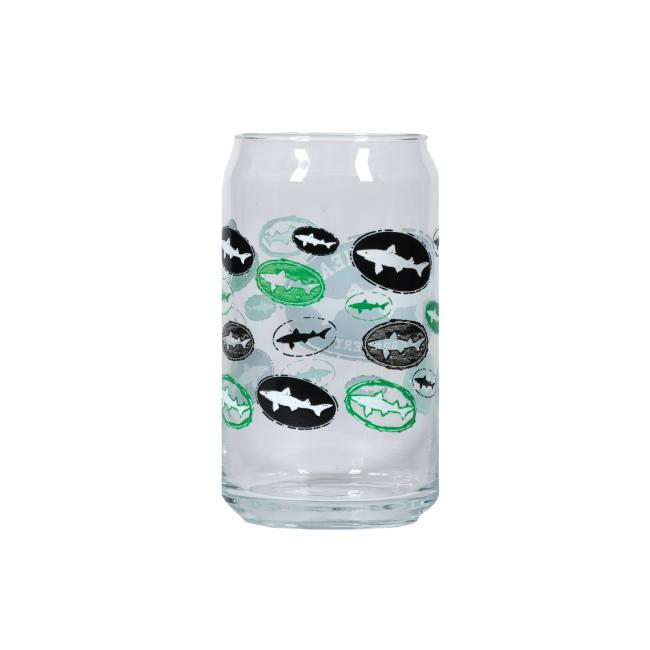 The Logo Can Glass by Grandstand Glassware & Apparel is a 16 oz soda can-shaped glass with oval shark silhouette logos in black, white, and green—ideal for sipping scratch-made spirits or ales. Shown empty against a plain white background.