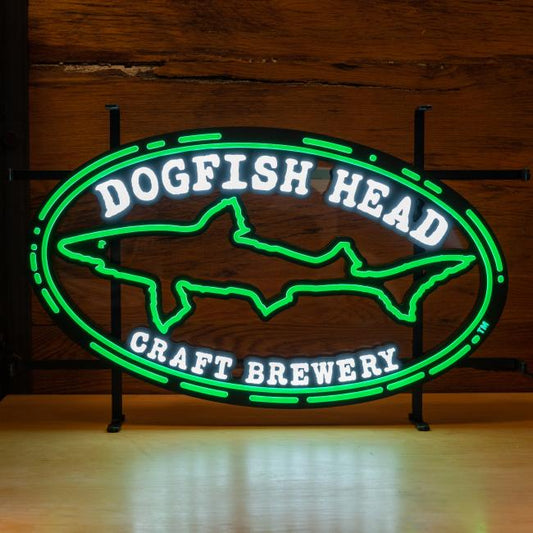 The Merchtank Craft Brewery Logo LED Neon features a green outlined shark and "Dogfish Head Craft Brewery" in white, displayed on wood, with durable LED lighting for lasting brightness.