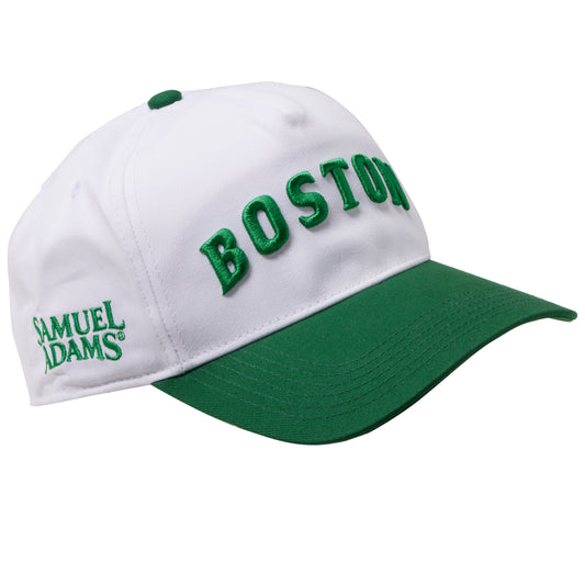 Samuel Adams Boston hat in white and green with embroidered “BOSTON” lettering, curved brim, and side Samuel Adams logo detail on structured cap