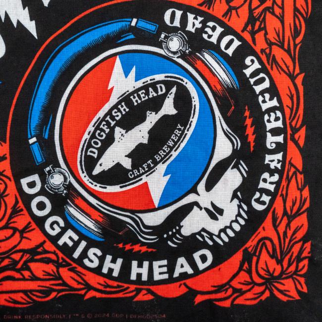The Merchtank Dogfish Head x Grateful Dead Black Bandana features a circular skull logo with a lightning bolt, headphones, and red accents, inspired by Grateful Dead art—the ideal craft beer accessory.