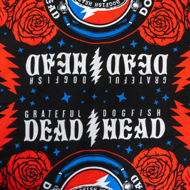 The Merchtank Dogfish Head x Grateful Dead Black Bandana features bold red roses, blue stars, and "GRATEFUL DOGFISH DEAD HEAD" with a lightning bolt mirrored on black—ideal for Grateful Dead or craft beer fans and collectors.
