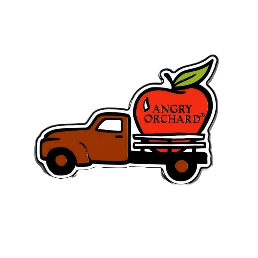 This magnet features a truck with a red apple in the trunk of it. The apple has writing "Angry Orchard" on it. 