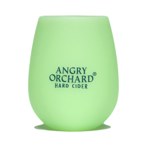 This glow in the dark glass has the writing "Angry Orchard Hard Cider" on the front.