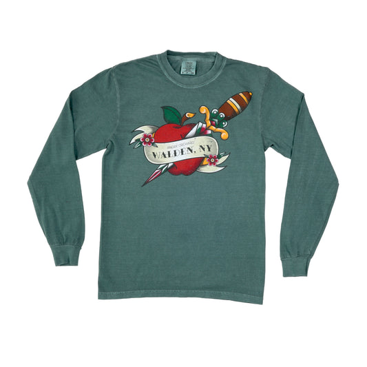 Dark green long sleeve, with an image of a red apple being impaled by a dagger from top left shoulder to bottom right chest. The apple is wrapped in a banner and two small purple flowers. Banner reads "Angry Orchard, Walden, NY"