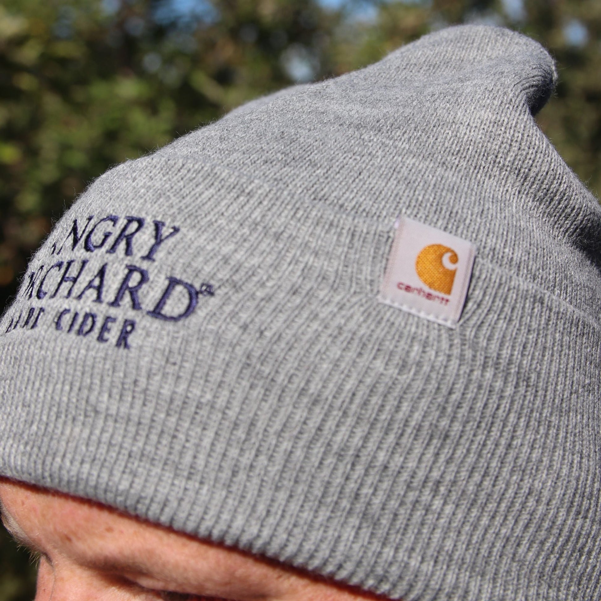 Close up of Grey Carhartt Beanie with Angry Orchard logo reading "Angry Orchard, Hard Cider"