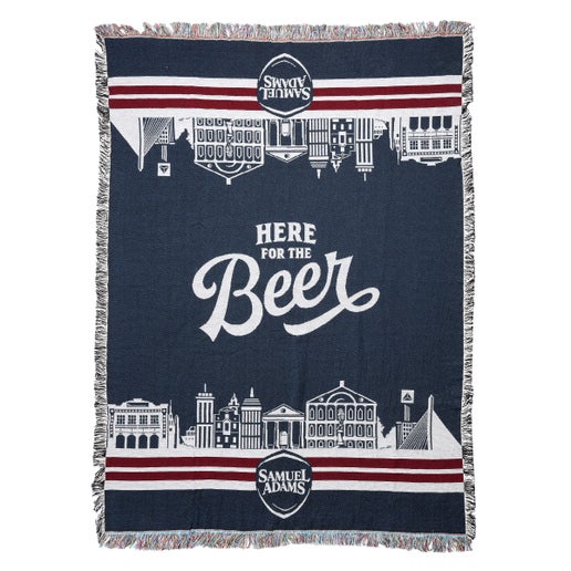 A 72" x 55" blanket that features the Boston skyline in white over a navy background and features the phrase "Here for the beer" in the center in white letters.