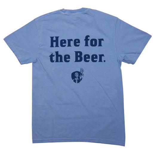 Back of tee features large writing, "Here for the Beer." in a darker blue. Underneath is the shield logo with Sam Adams hoisting a beer.