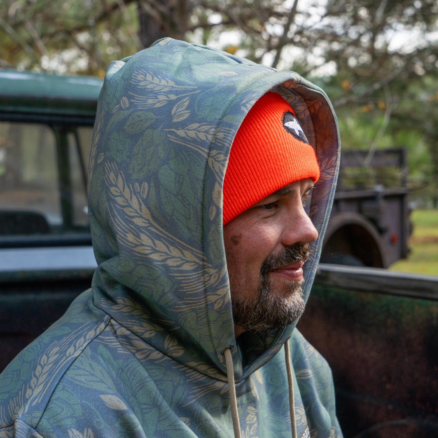 Close up of the hood being worn by a person also wearing an orange Dogfish beanie.