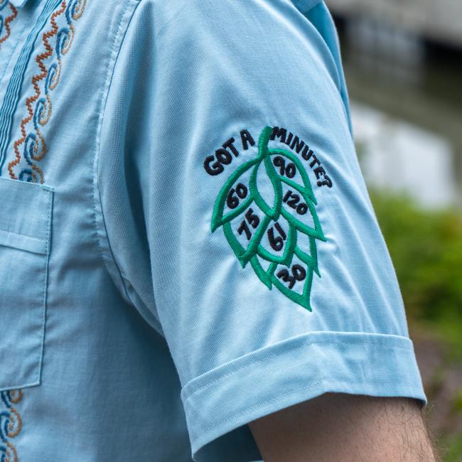 Close up of the Got a Minute design featured on the bottom of the left sleeve. The hop design features the numbers 60, 75, 61, 30, 120, and 90 on different lobes of it.