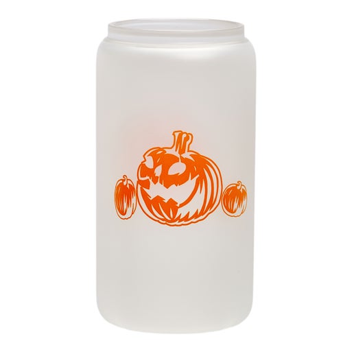 Color changing can glass features imagery of orange pumpkin on the front with a smaller one on both sides of the larger. Glass is pictured on a white background showing the glass color when not filled.
