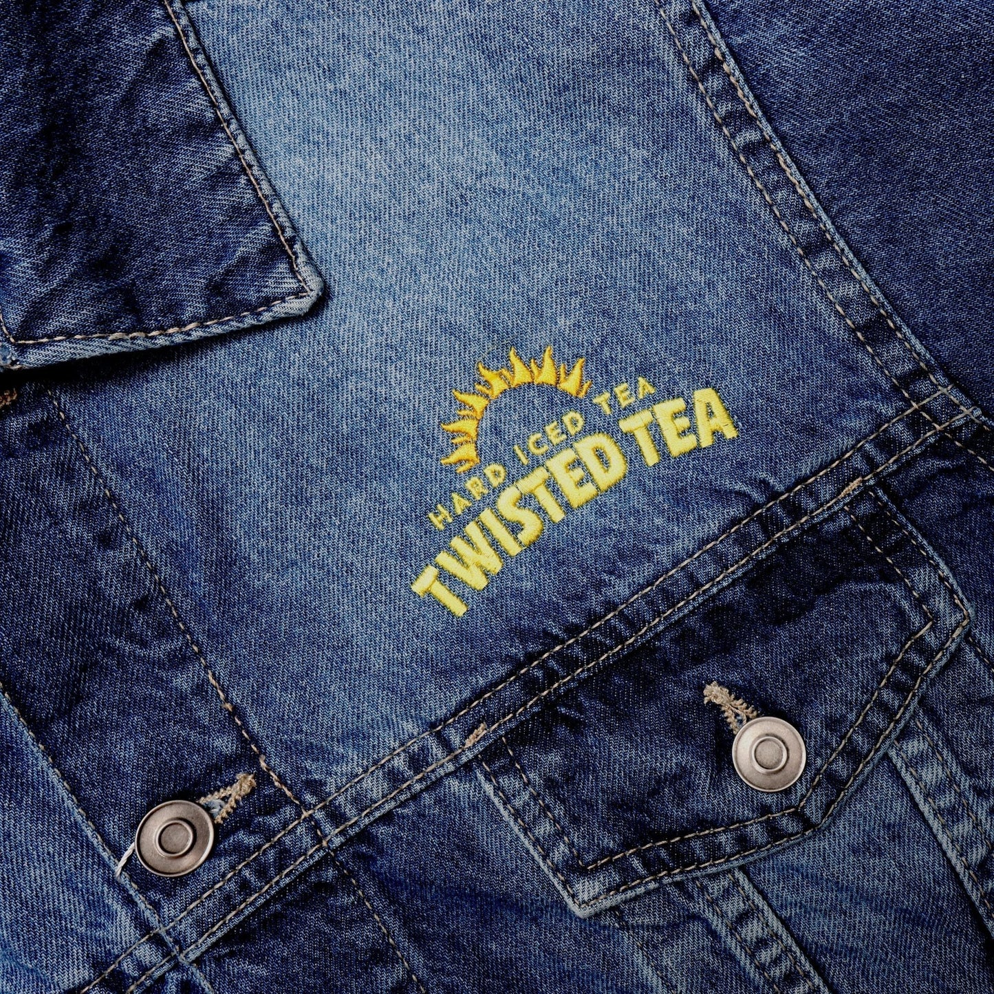 Embroidered Twisted Tea logo on a denim jacket