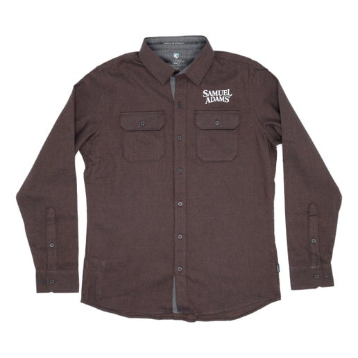 The KUHL Brown Descendr Flannel features securable chest pockets, an interior security pocket, 2-button adjustable cuffs, and a white Samuel Adams logo above the left side chest pocket.