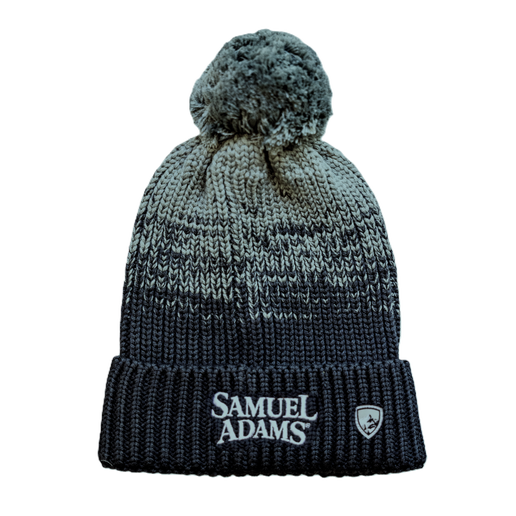 Gradient color-blocking beanie with pom-pom on top. Featuring a woven KÜHL® crest on the bottom left of the fold over next to a centered Samuel Adams logo.