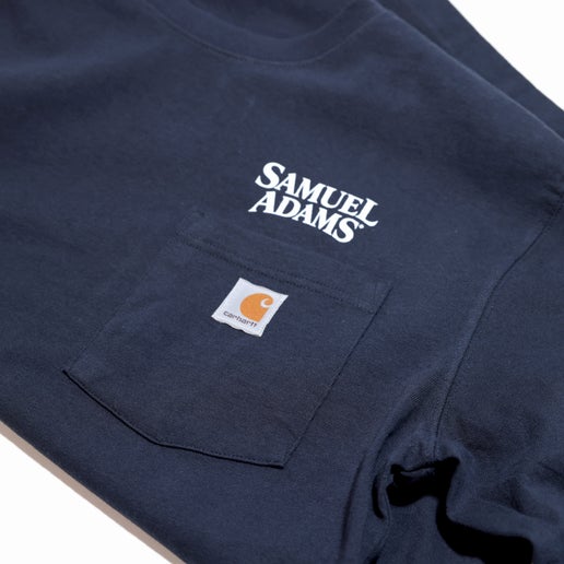 Samuel Adams-branded Navy Carhartt Long Sleeve Pocket Tee with Rib-knit crewneck and cuffs. Left-chest pocket feature with sewn-on Carhartt patch and Samuel Adams logo above.