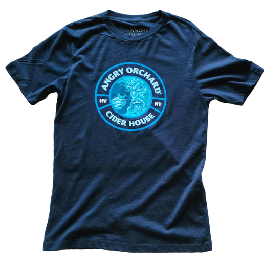 This is a navy tee with a light blue emblem centered to the tee. In the center is an image of the Angry Orchard tree trunk with a face on it. Around the image is writing including, "Angry Orchard Cider House", "HV", and "NY". The back of the tee is solid navy.