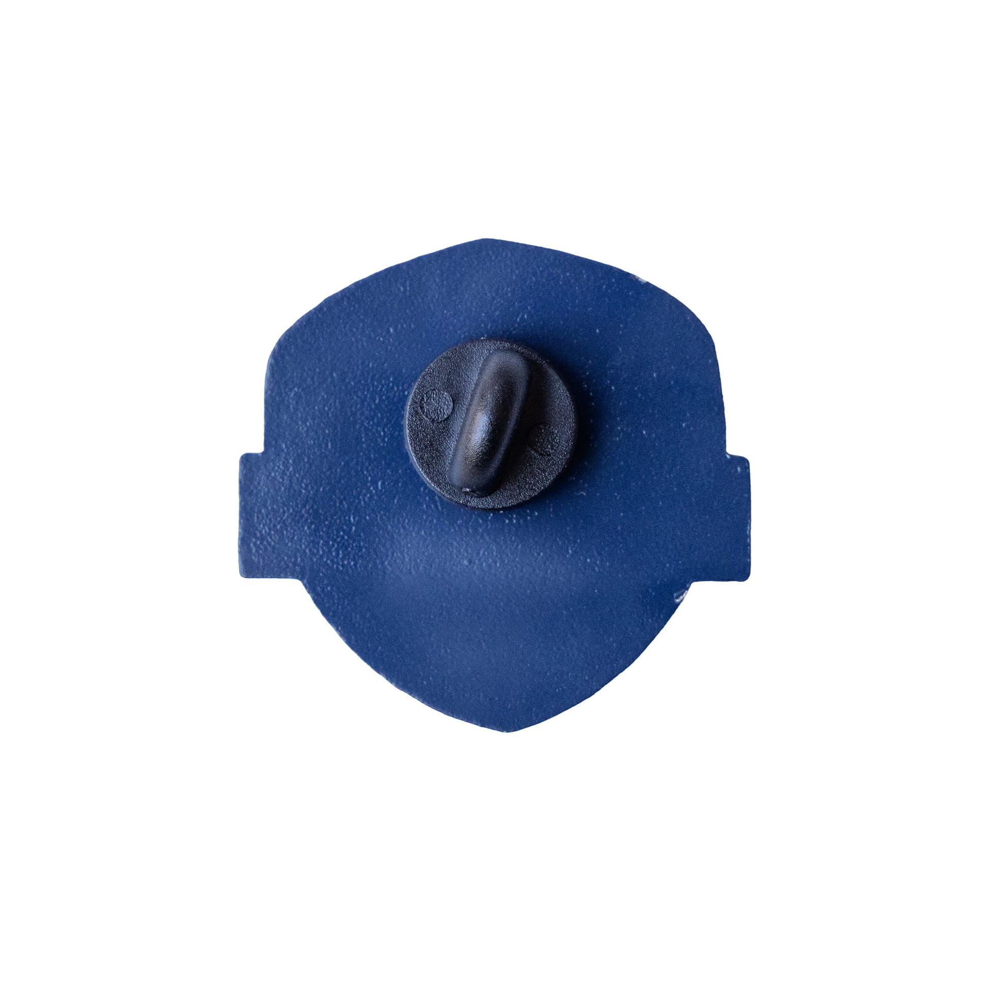 Back view of Samuel Adams enamel pin showing solid navy blue metal backing with single black rubber clutch fastener and smooth shield‑shaped silhouette