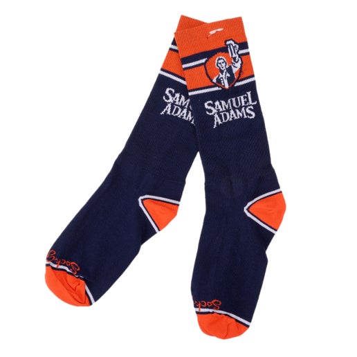 Navy socks with orange calf, heels and toes. Calf area features classic Sam Adams beer hoisting logo and "Samuel Adams" written underneath.